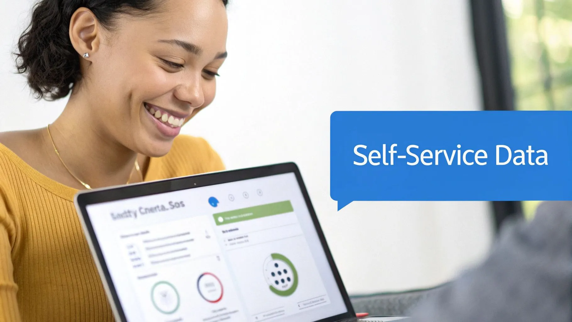 A smiling woman in a yellow top happily uses a laptop showing self-service data insights.